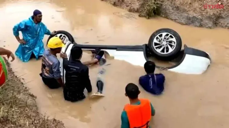 Driver Rescued After Sedan Swept Into Canal by Floodwaters
