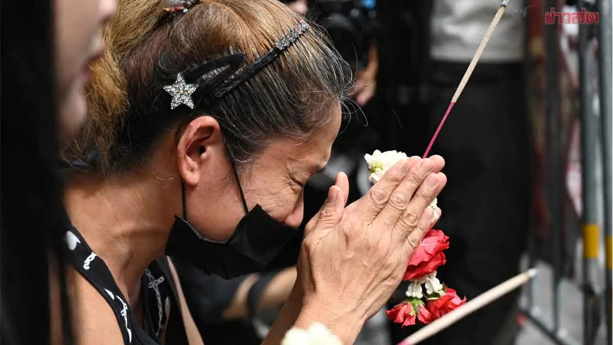 Grieving Mother Lays Flowers as Fire Victims Mourned