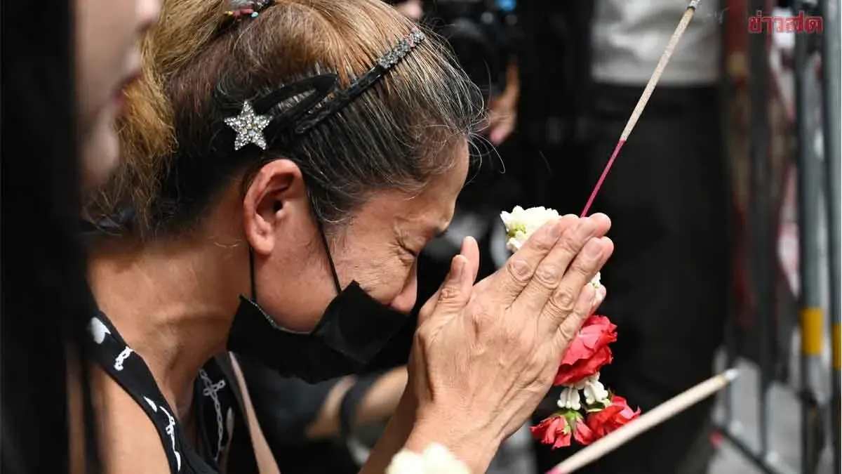 Grieving Mother Lays Flowers as Fire Victims Mourned