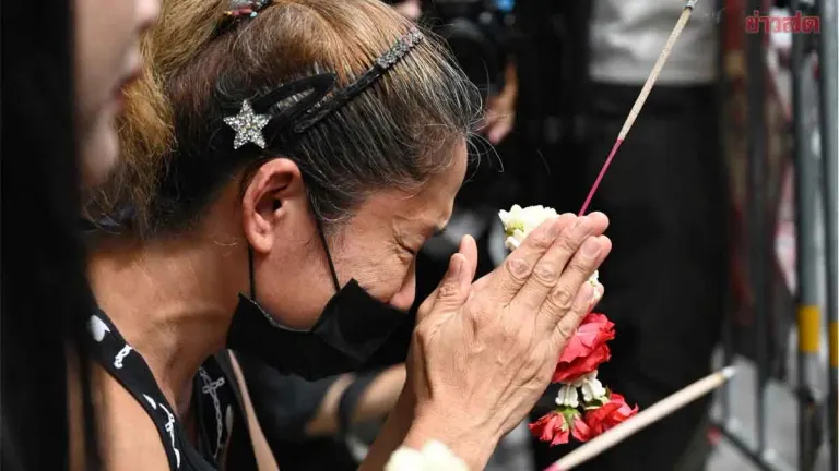 Grieving Mother Lays Flowers as Fire Victims Mourned