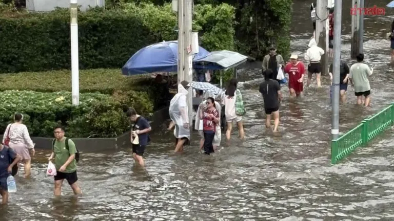 Bangkok Intersection Remains Flooded as Commuters Wade Through Waters